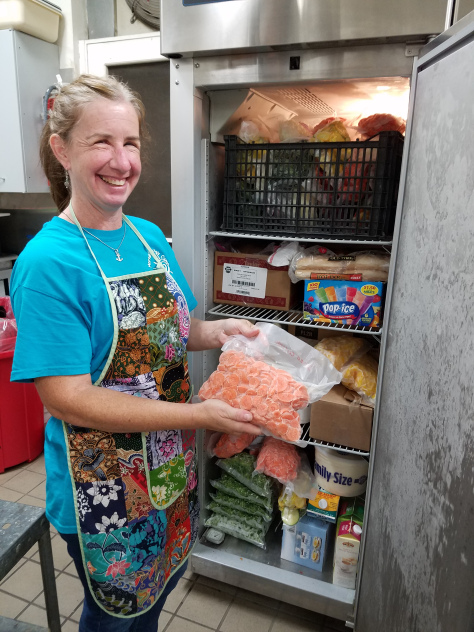 CFR MEMBERS BUILD THEIR CAPACITY TO SERVE woman at freezer